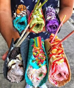 Sweet Rolled Tacos Assorted hand rolled ice cream tacos featuring Rainbow Road, Just Say Cheese (strawberry cheesecake), Monster Inc, Yammie (ube ice cream with coconut shavings and whipped cream), etc.