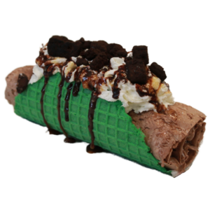 Chocolate hand rolled ice cream mixed with brownie bites and chocolate drizzle, topped with whipped cream, brownie bites, chocolate drizzle, and tucked into a green taco